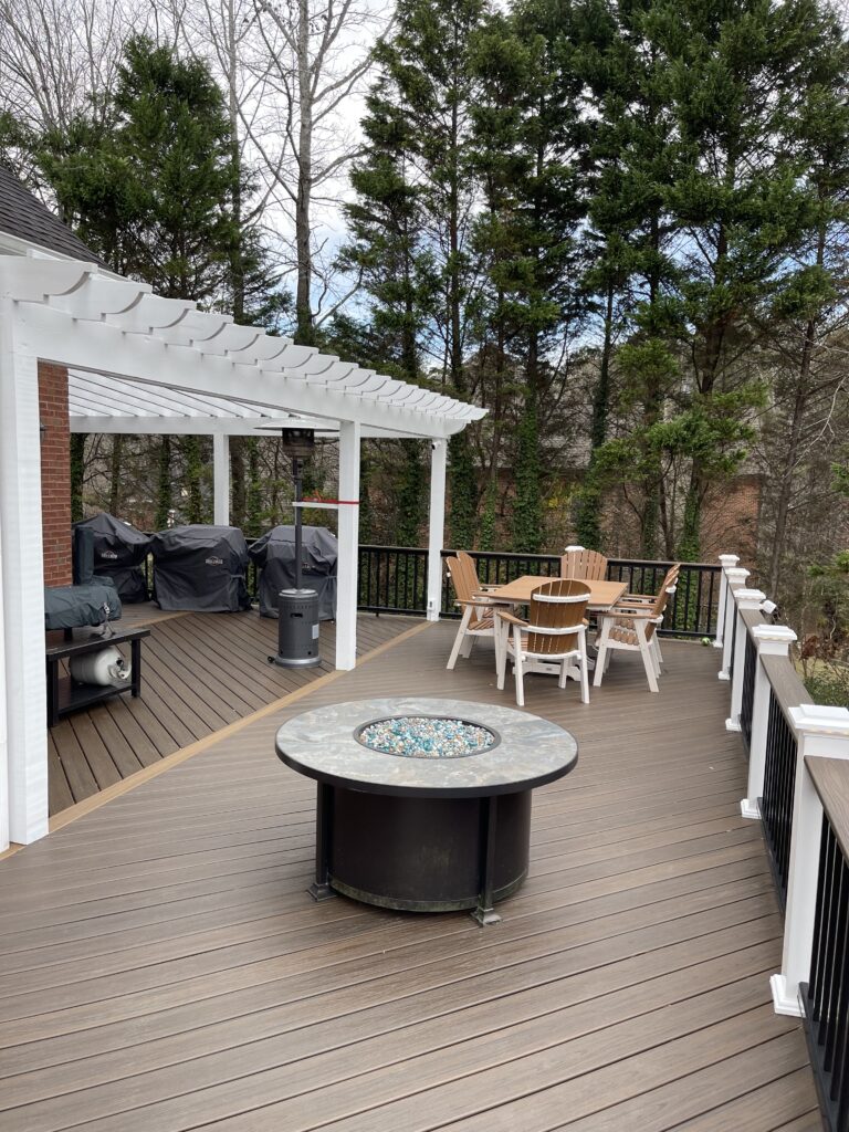 Composite deck with a fire pit and outdoor dinning table