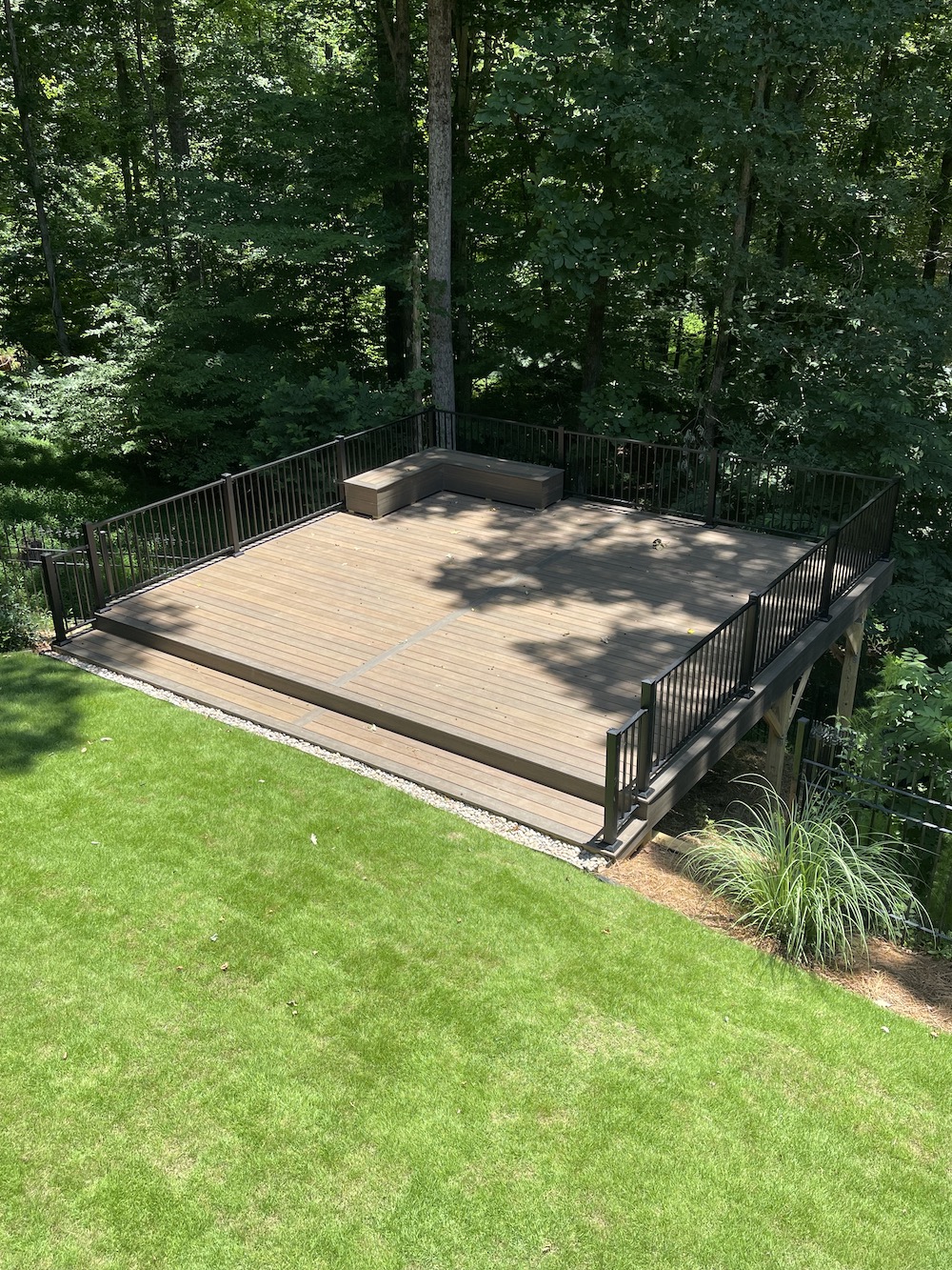 Commercial deck with custom deck seating with beautiful view of trees and lawn