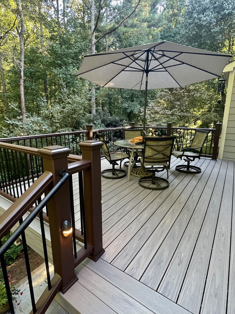 Composite deck with outdoor table and chairs with overlooking view of the nature