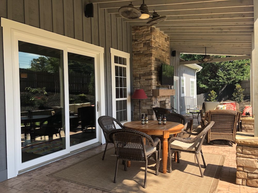 Porch internal view with big glass door and outdoor furniture