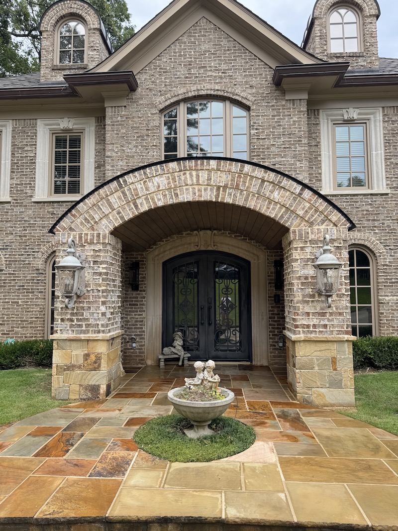Portico with black gate and have a lot of windows house