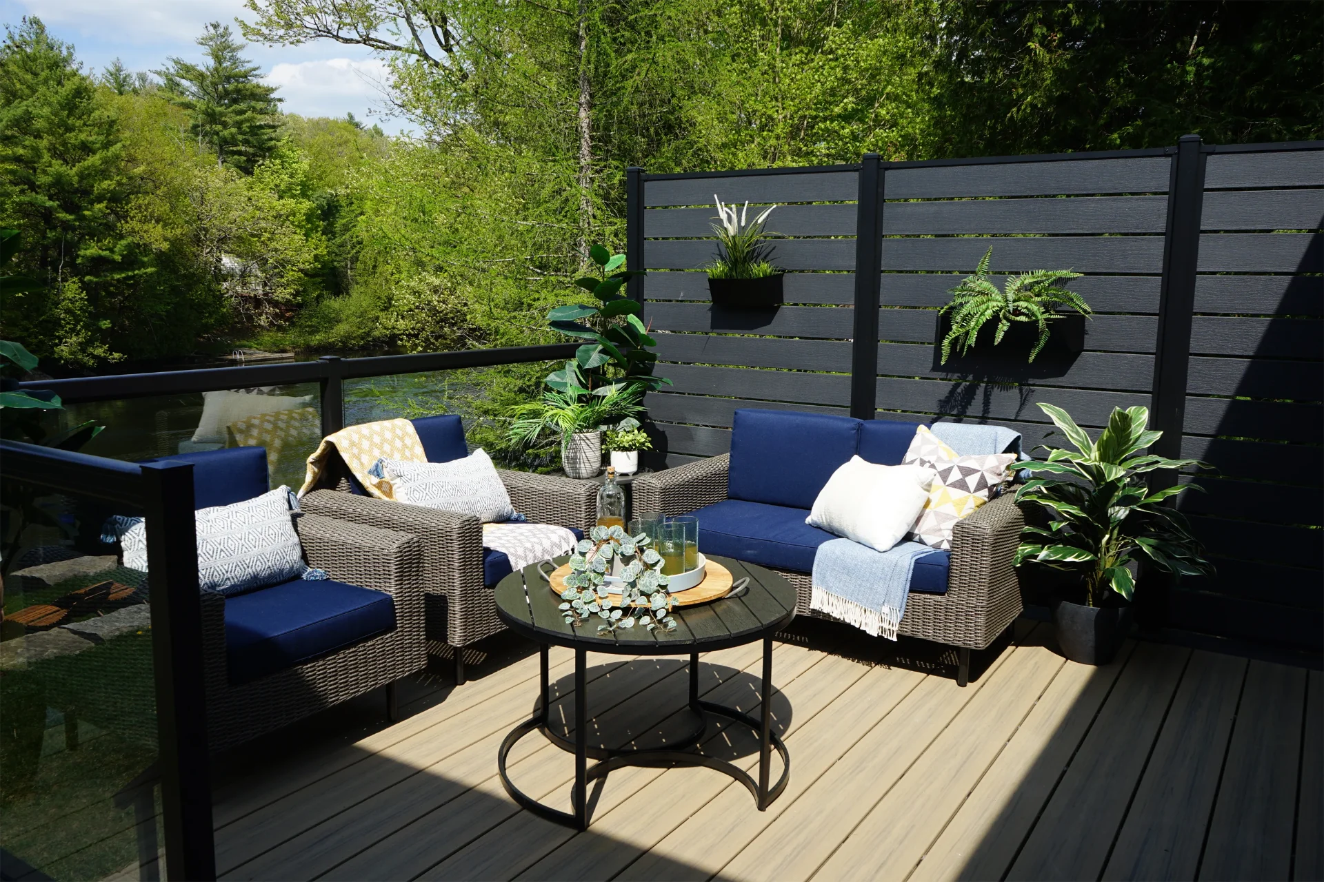 Privacy slats walls with plants on it and outdoor living furniture with overlooking view