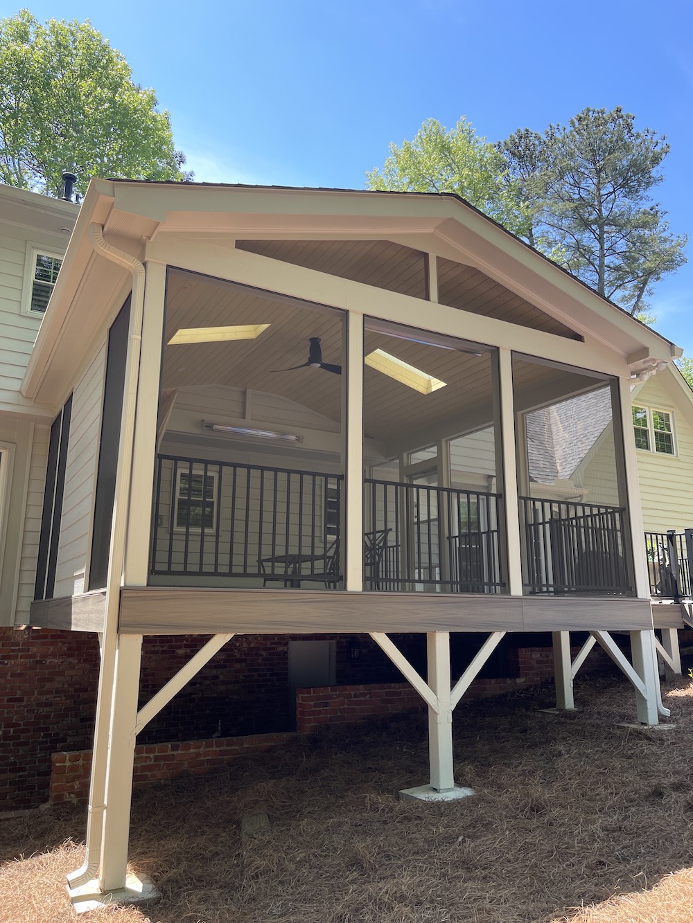 Raised deck with porch and privacy screen with black railing