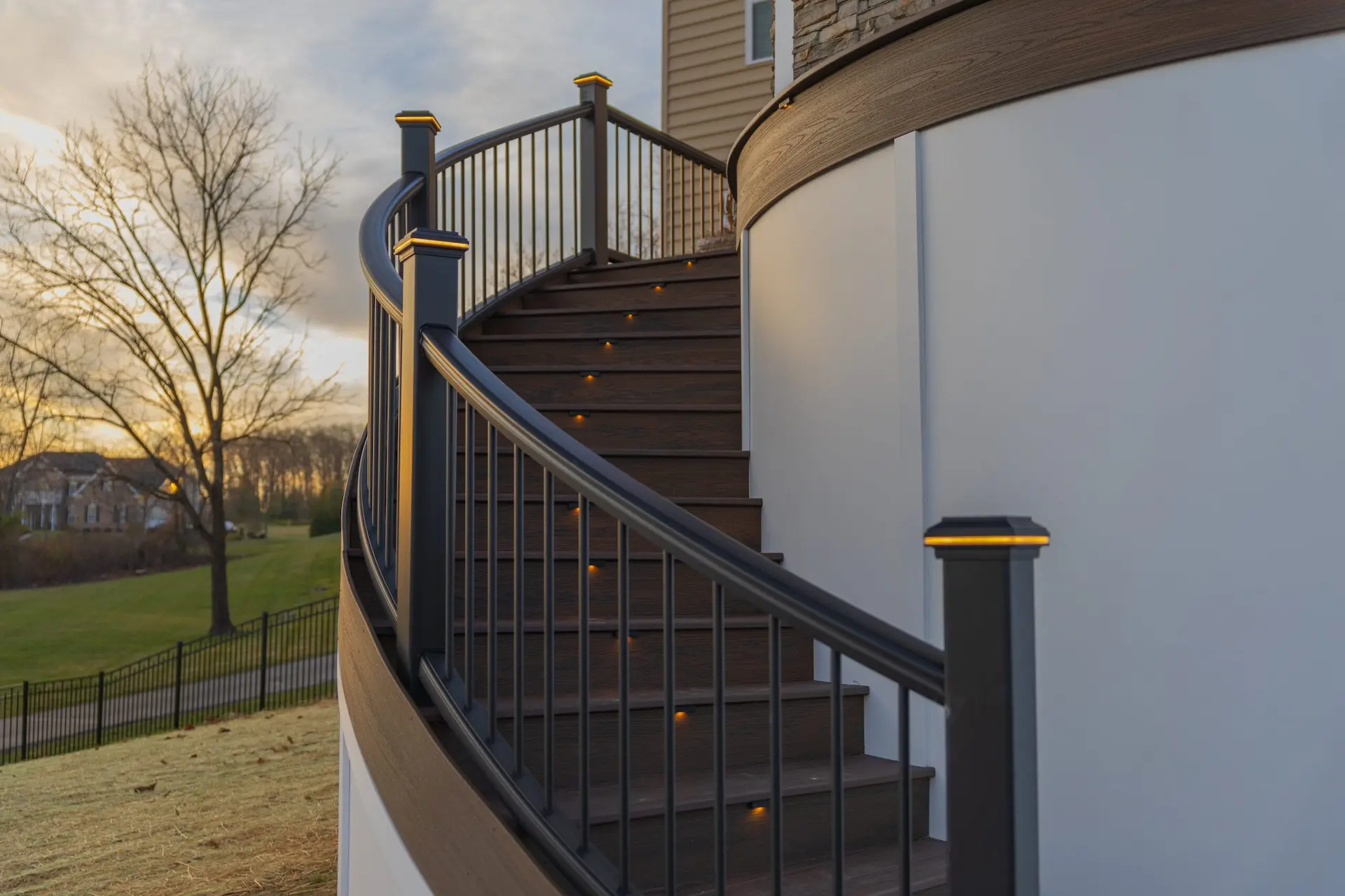Scapes deck lightning on it with black railing
