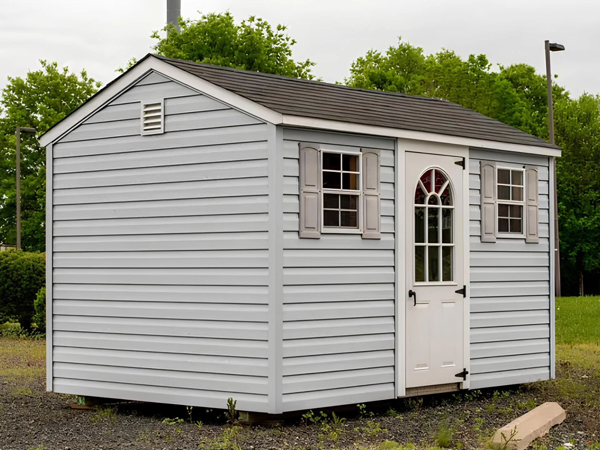 Shed with white door and two windows on it