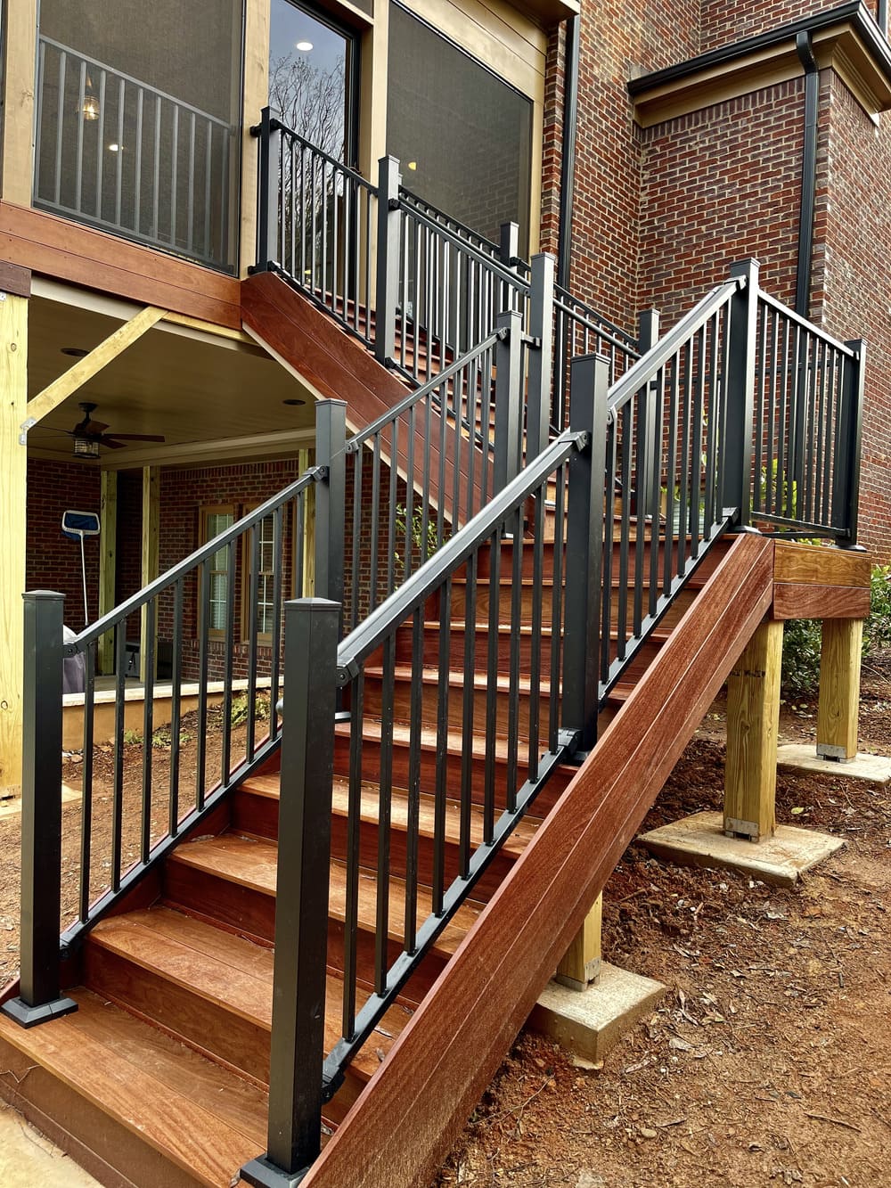 Wooden stairs and black deck railing